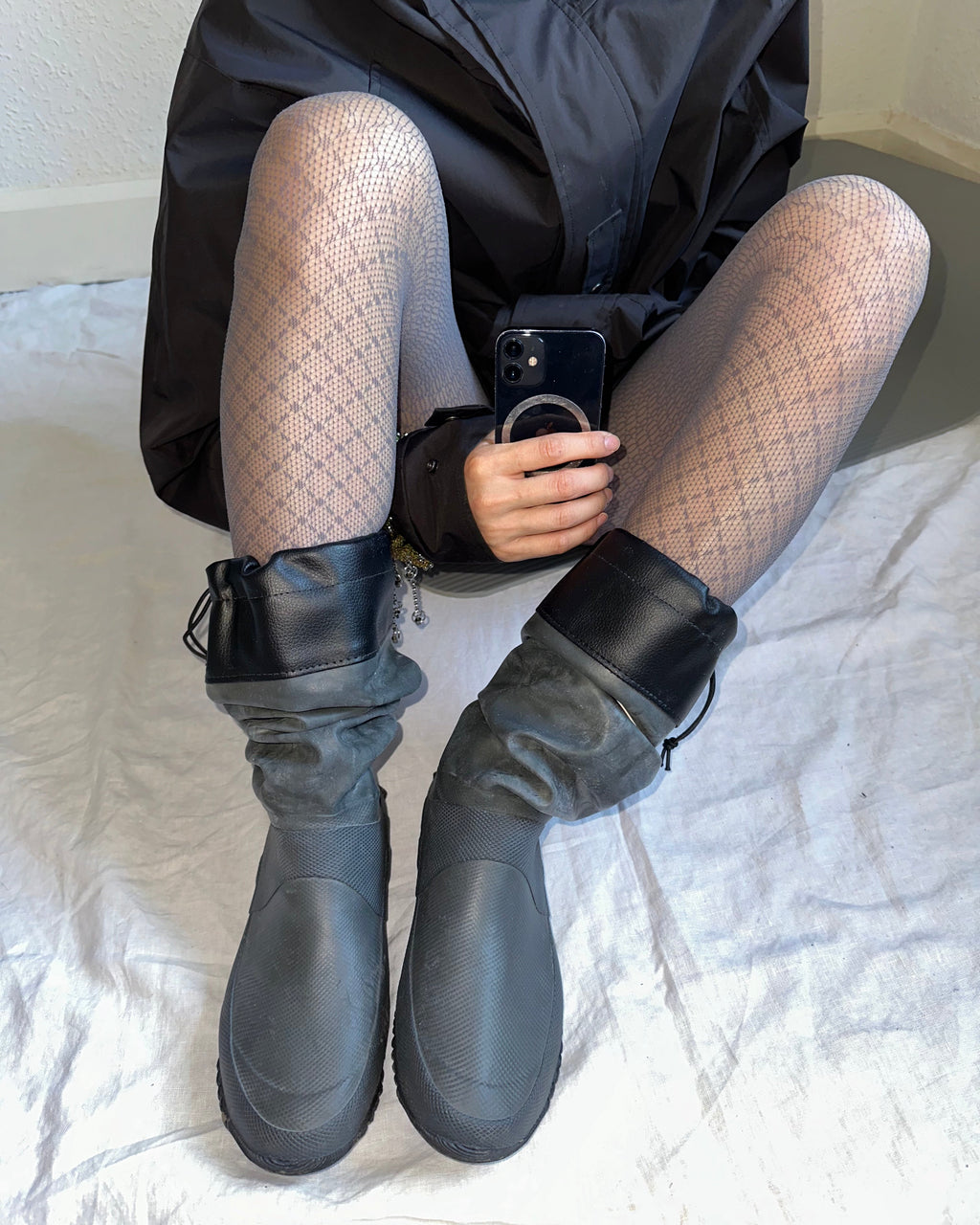 grey lace tights with black rain coat and dark green rain boots